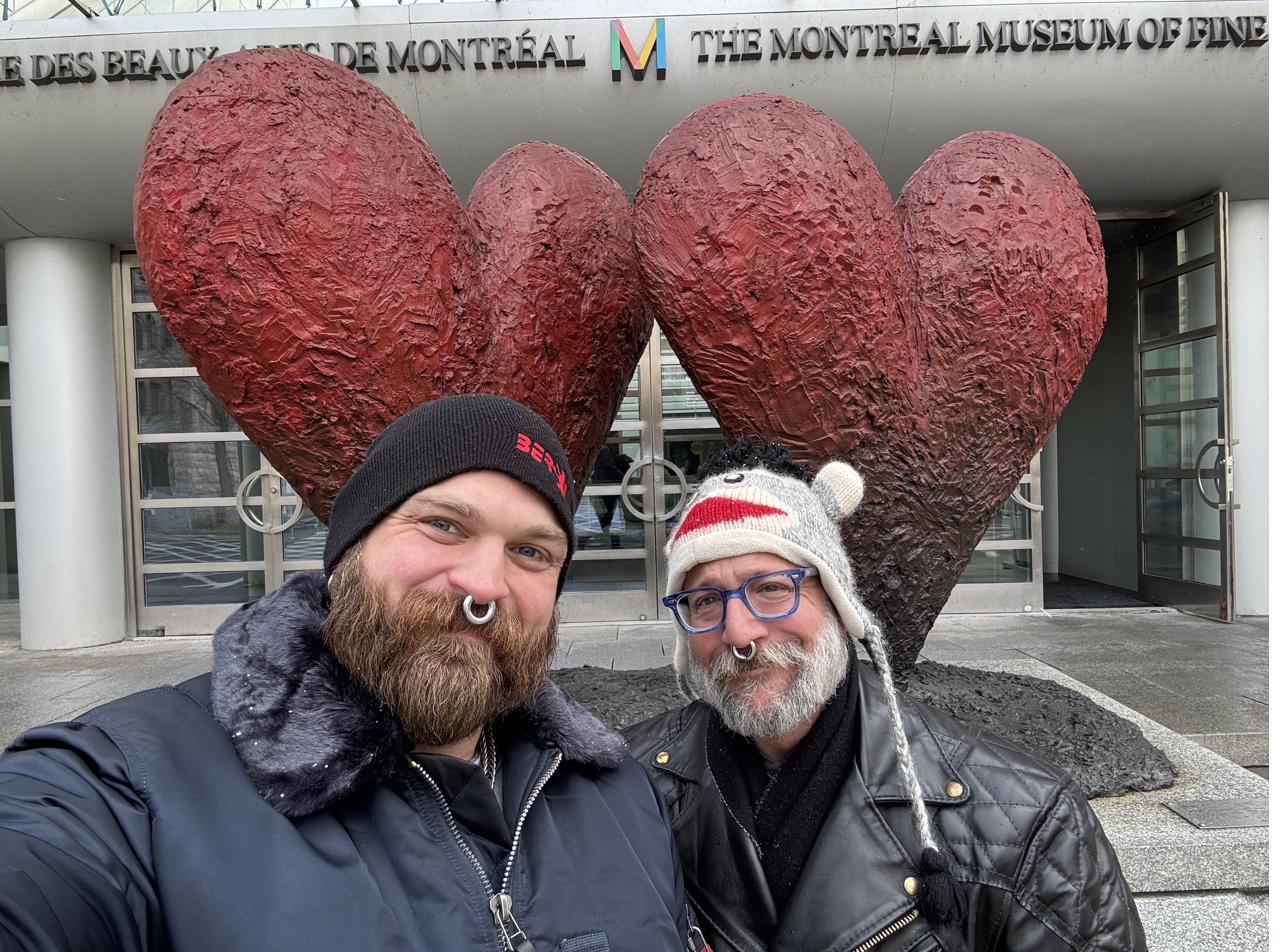 Barclay Barrios standing in front of a heart sculpture outside the Montreal Museum of Fine Arts.
